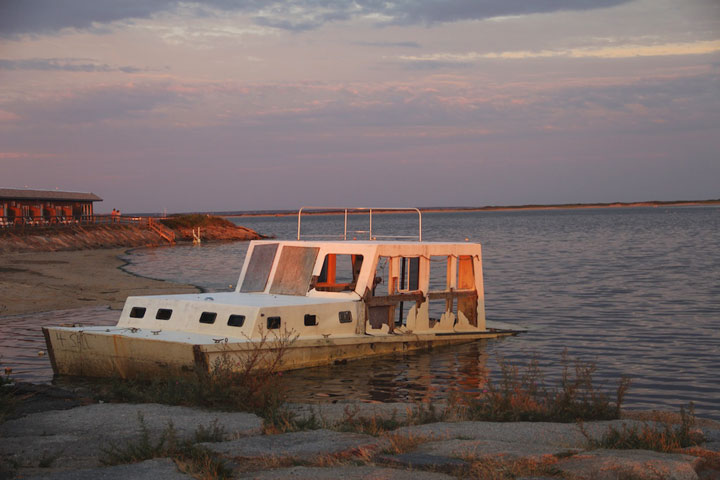 Provincetown West End... almost sunken boat in sunset light; photograph by Ewa Nogiec